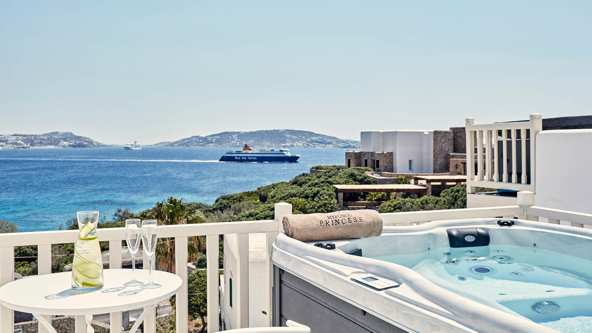 Blissful balcony retreat at Mykonos Princess Hotel: Mykonos suite boasts a private jacuzzi overlooking the Aegean Sea, complete with a refreshing lemon water setup.