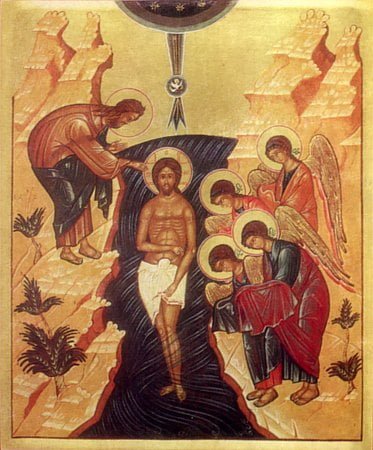 The image is a Byzantine icon depicting the Christian Epiphany scene. In the center stands Jesus Christ, bearing a halo, immersed in water up to His knees, symbolizing the River Jordan. Above Him, the heavens open with a dove, representing the Holy Spirit, descending towards Him. To the left, John the Baptist, cloaked in camel hair, places a hand on Christ's head, performing the baptism. On the right, an angel with a halo stands in reverence. The background features stylized mountains and plants, with two angels in the upper corners, witnessing the event.