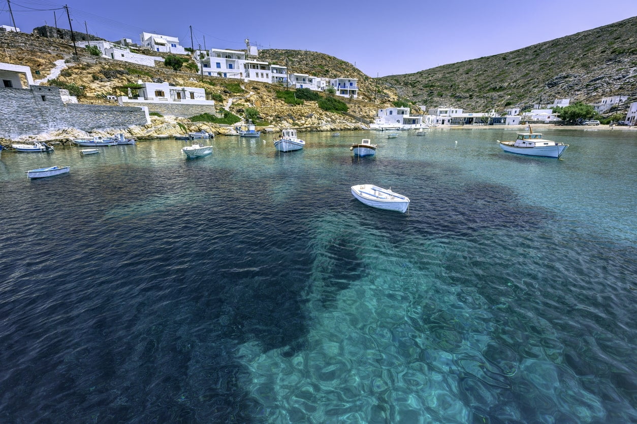 village of Heronissos, with fishing boats and transparent waters, in Sifnos island, Greece