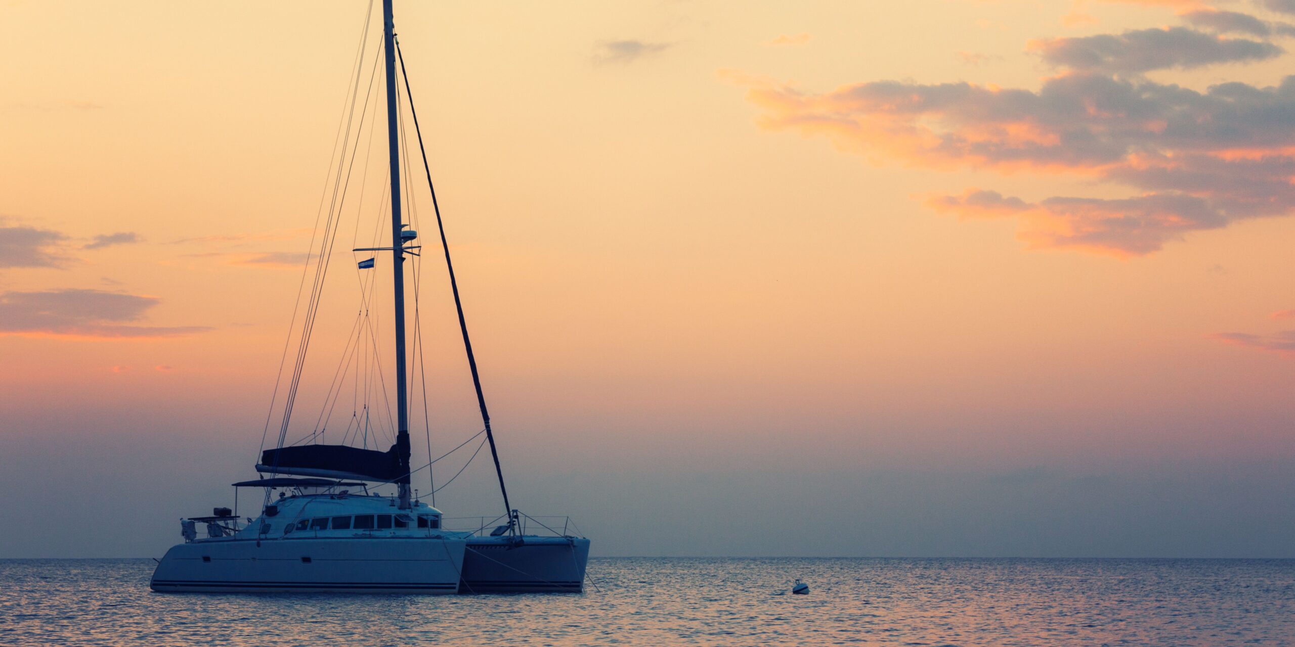 catamaran sailing during sunset in santorini