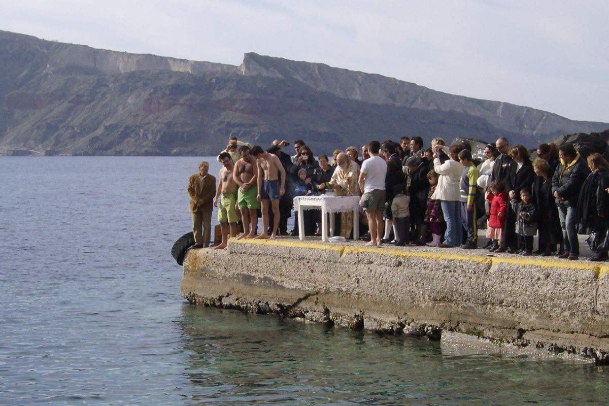 Oia, Santorini, Greece - 6th January 2008: Unidentified Greek Orthodox Priest and pilgrims celebrating the Epiphany Feast Day.