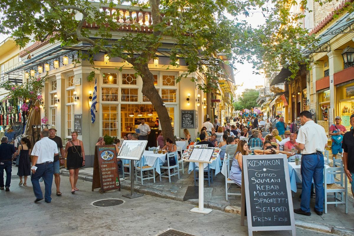 Athens, Greece - June 30, 2018. A terrace of a Greek restaurant at Plaka neighborhood of Athens city, offering typical Greek food on a blackboard. Attica region, Greece.