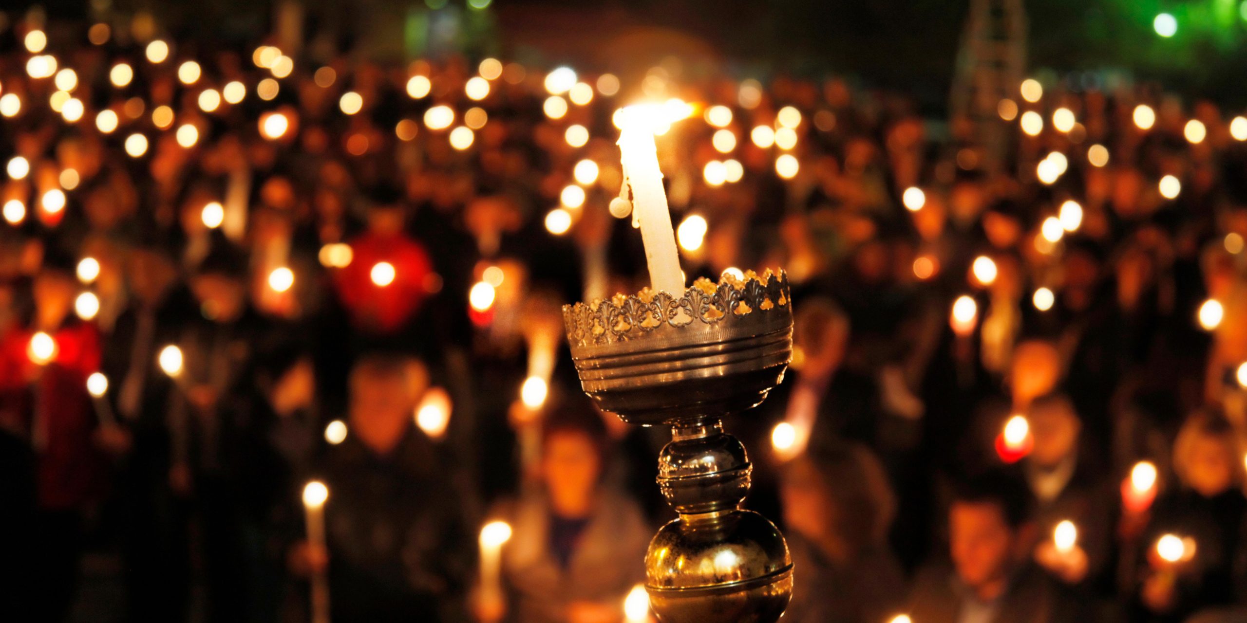 holding candle vigil in easter resurrection