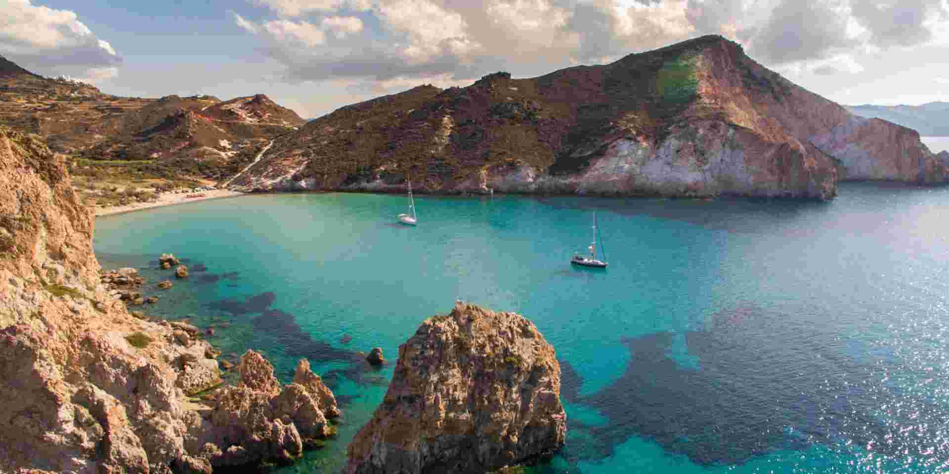 Crystal clear water in calm bay of Milos island is very attractive for sailboats and yachts milos island beach_feature