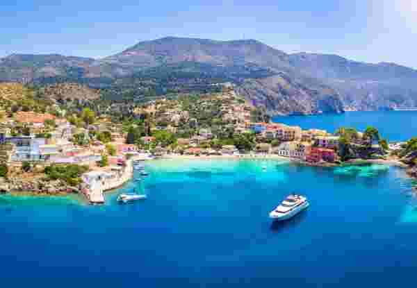 Aerial view to the beautiful fishing village of Assos on the island of Kefalonia, Greece, surrounded by turquoise sea and green hills with Pine Trees_June Islands Kefalonia island_June Islands_feature