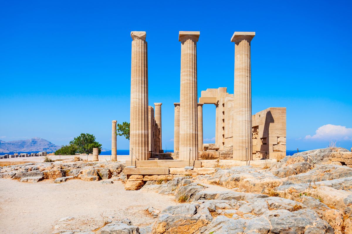 Stone columns from the acropolis of Rhodes, set against a bright blue sky.