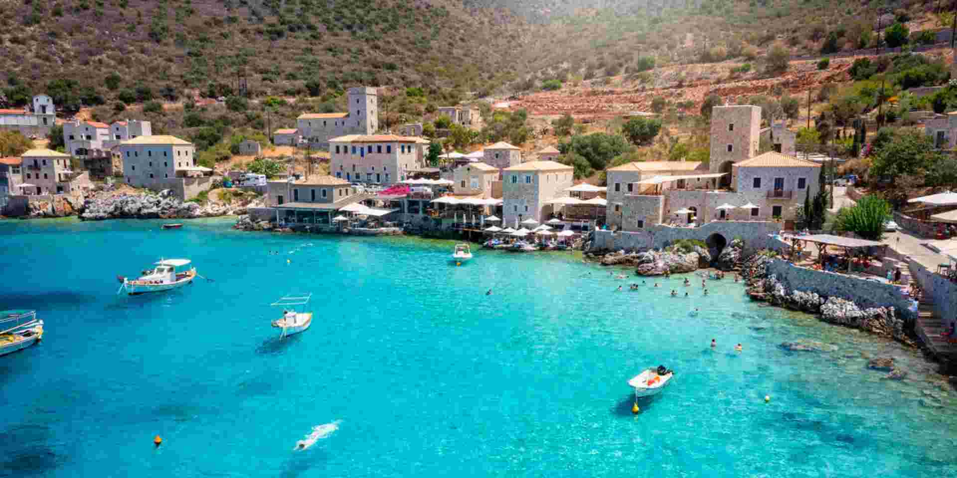 The beautiful village Limeni on the south Mani coast, Peloponnese, Greece, with shining, turquoise sea during summer time Limeni in Mani_feature