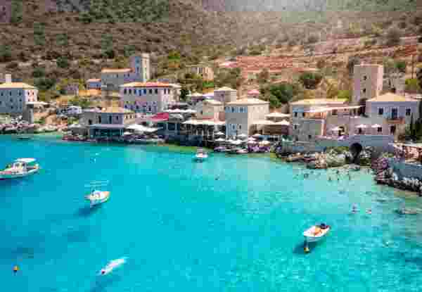 The beautiful village Limeni on the south Mani coast, Peloponnese, Greece, with shining, turquoise sea during summer time Limeni in Mani_feature