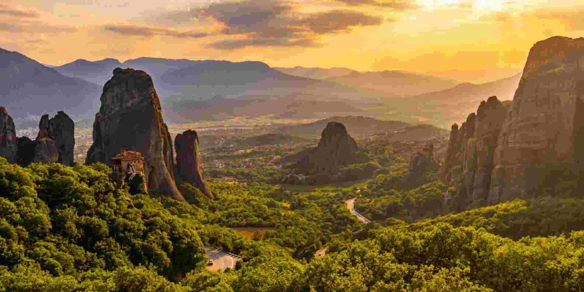 Scenic view of famous Meteora monastery against cloudy sky during sunset Meteora_feature