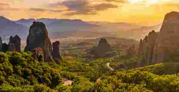Scenic view of famous Meteora monastery against cloudy sky during sunset Meteora_feature