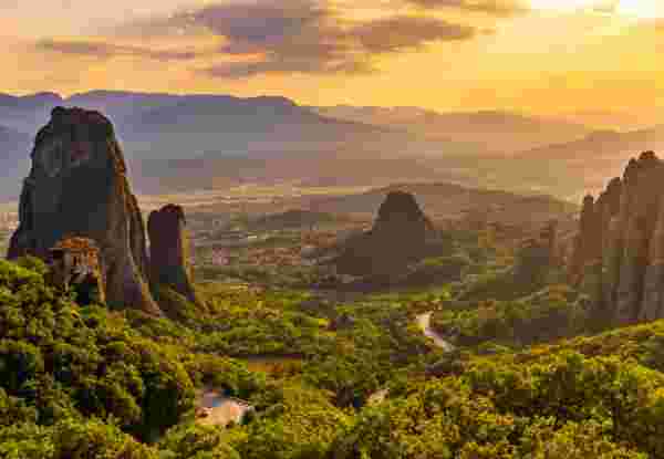 Scenic view of famous Meteora monastery against cloudy sky during sunset Meteora_feature