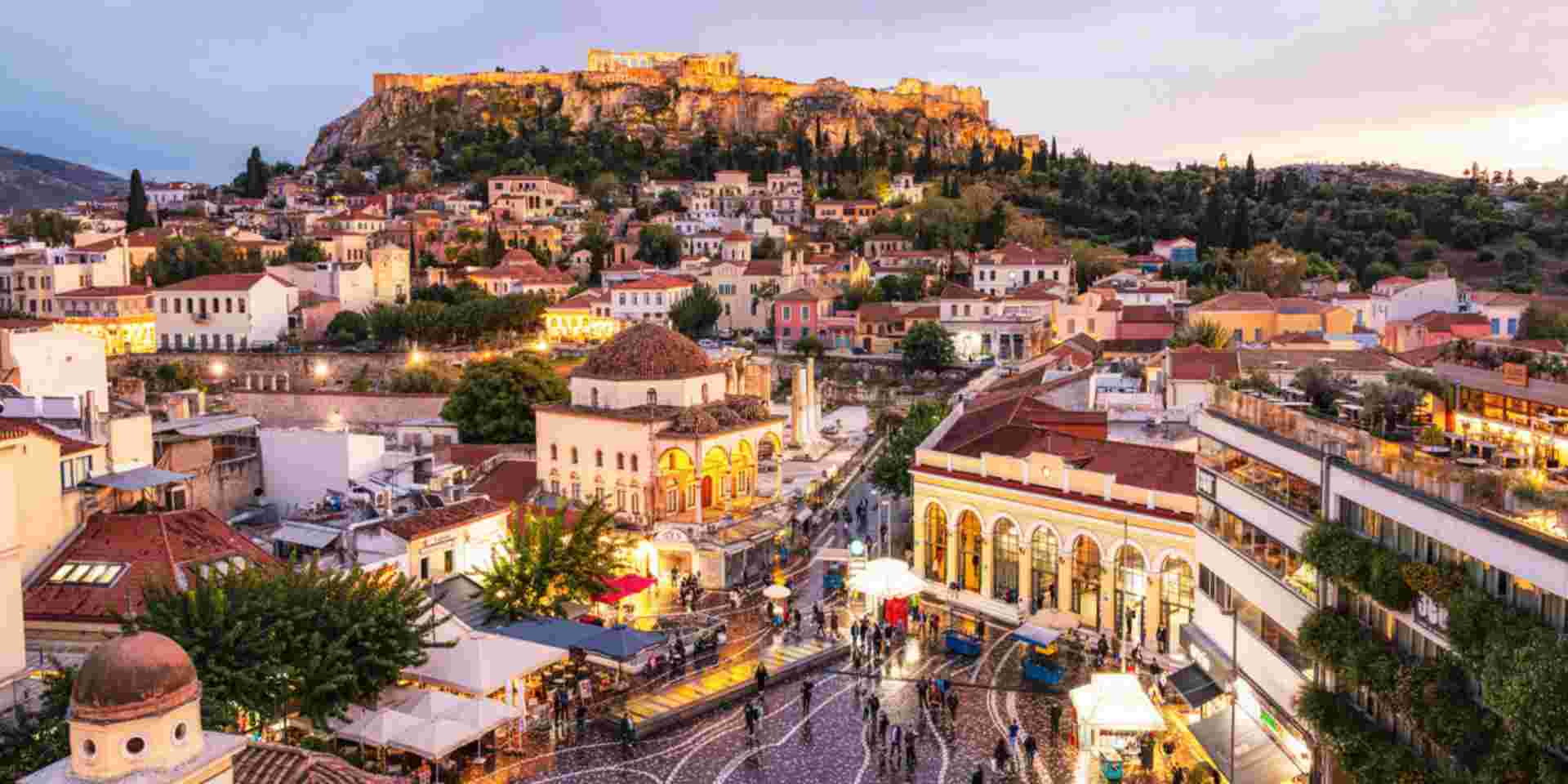 A high angle cityscape of Athens, with Monastiraki Square in the foreground, and the Parthenon on the Acropolis on the horizon_family trip greece Athens_feature_family trip greece
