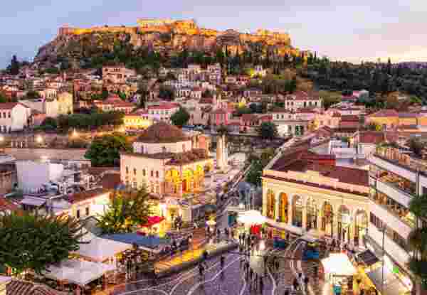 A high angle cityscape of Athens, with Monastiraki Square in the foreground, and the Parthenon on the Acropolis on the horizon_family trip greece Athens_feature_family trip greece
