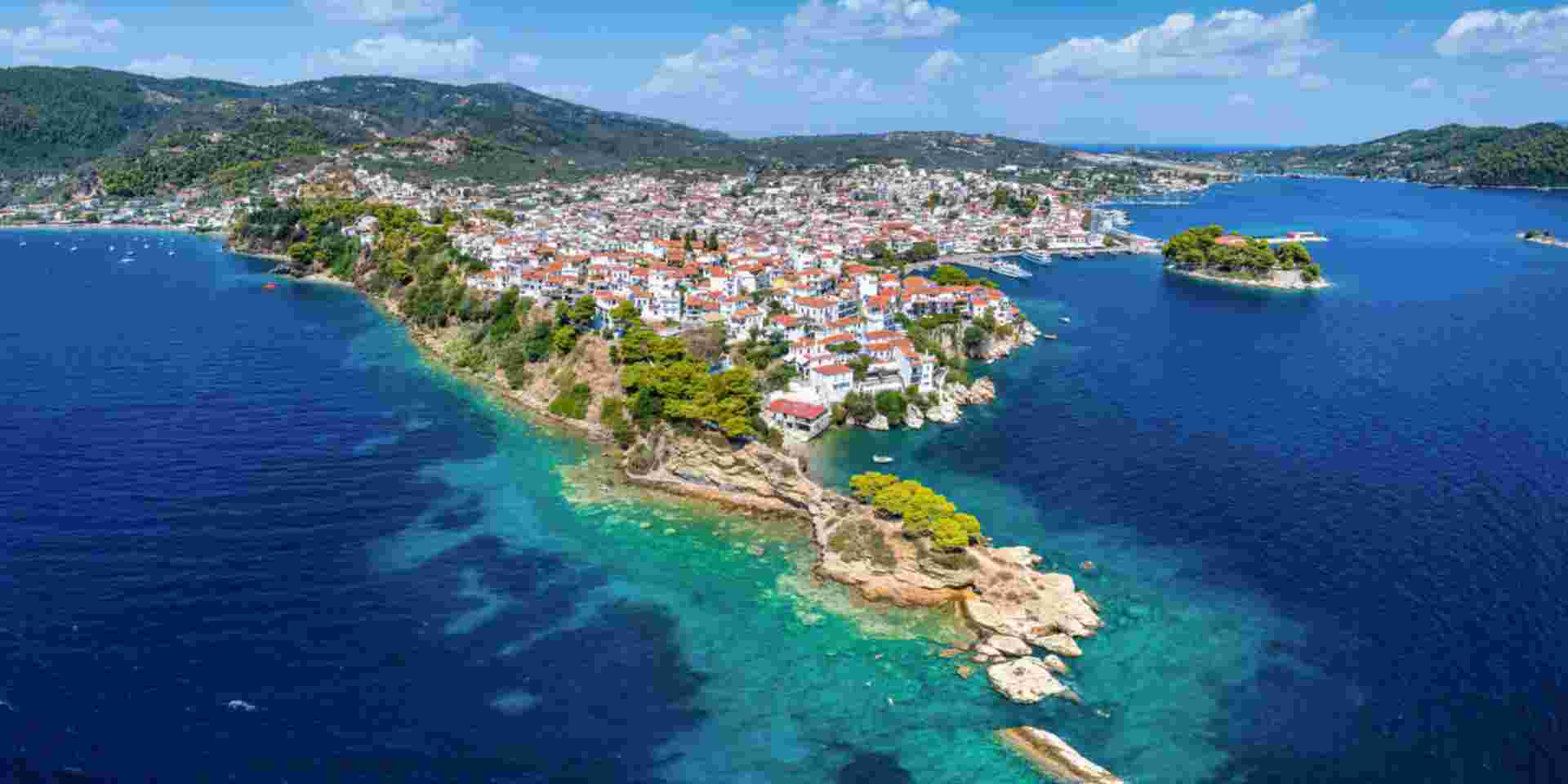 Panoramic aerial view of the town of Skiathos island, Sporades, Greece, with Bourtzi peninsula and Plakes area in front skiathos_feature