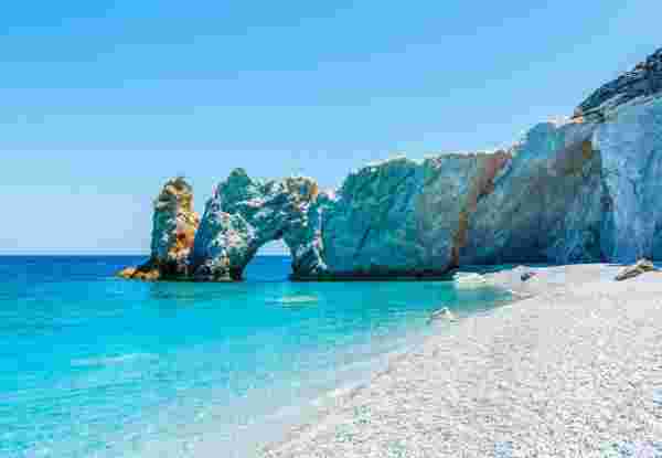 Lalaria Beach in Skiathos features clear blue water, a distinctive rock arch, and a pristine pebble shore. Lalaria beach skiathos