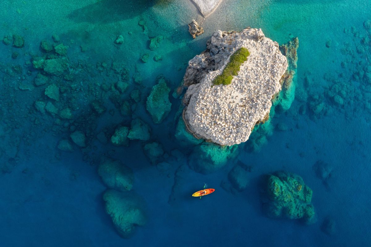 Aerial view of a woman kayaking near Sougia, Crete (Greece).
