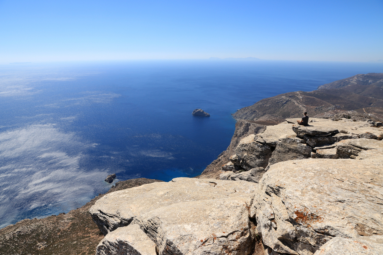 sea, earth, sky, mountains, meditating, sitting, looking at viewe