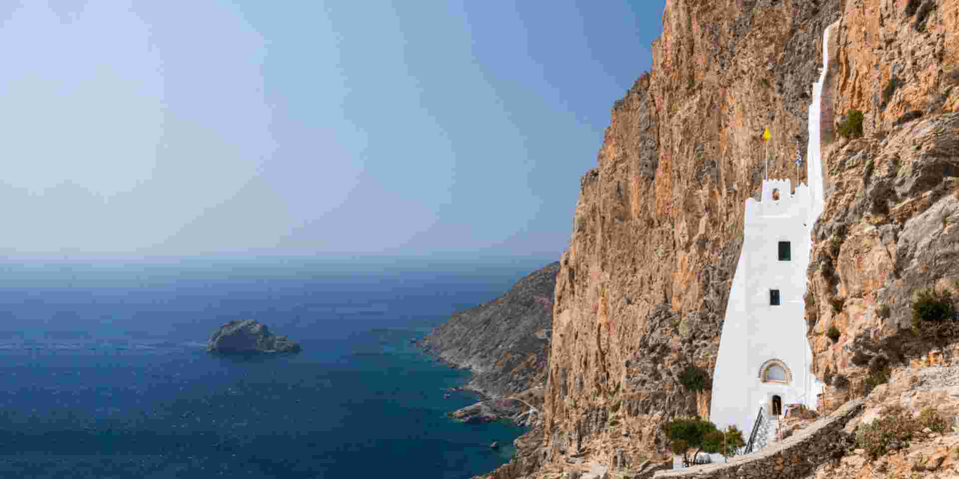 On the southern coast of the island of Amorgos in Greece, the monastery of Hozoviotissa stands on a rocky cliff and faces the deep blue of the Aegean sea. It is almost 1000 years old, the construction began in 1088 AD. monastery of Hozoviotissa_Amorgos_feature