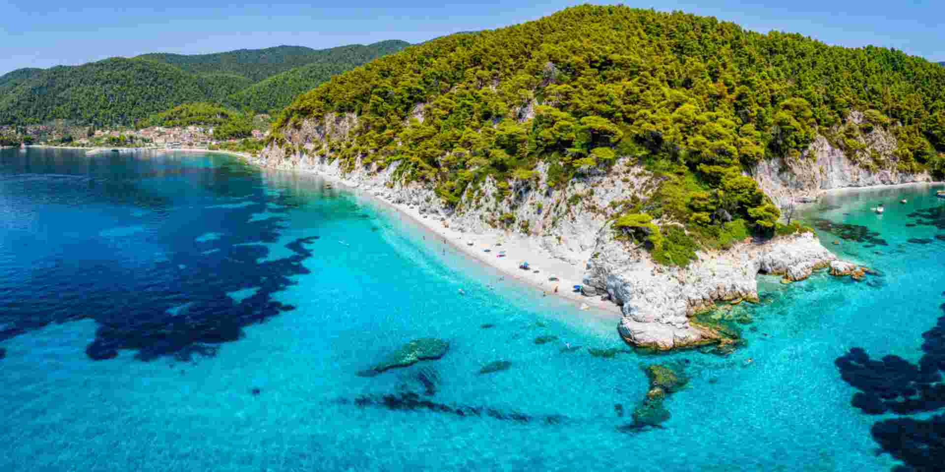 The beautiful coast of Skopelos island at Hovolo beach, Sporades, Greece, with turquoise sea and lush pine tree forest hovolo beach_skopelos_feature