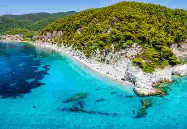 The beautiful coast of Skopelos island at Hovolo beach, Sporades, Greece, with turquoise sea and lush pine tree forest hovolo beach_skopelos_feature