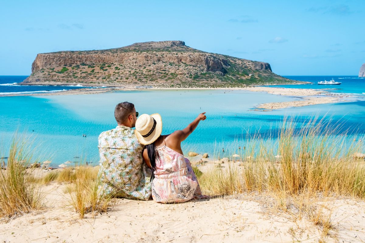 Crete Greece, Balos lagoon Crete island, Greece. Tourists relax at the crystal clear ocean of Balos Beach. a couple of men and a woman visit the beach during a vacation in Greece on a sunny day