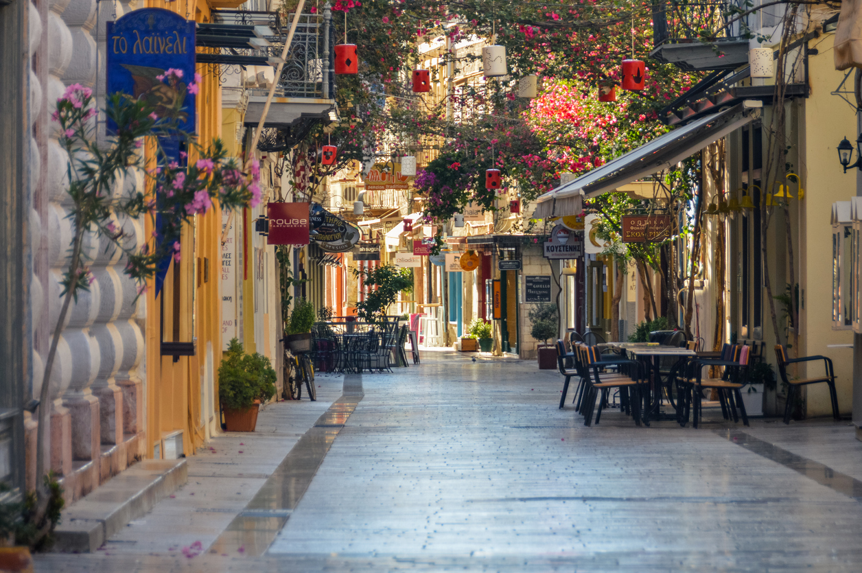Colorful streets of the old part of Nafplio. Photo taken during a summer morning, and contains several local businesses.