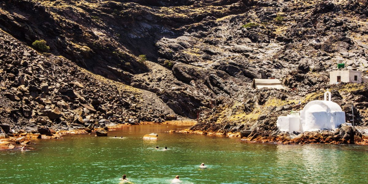 hot springs in santorini with people swimming in them