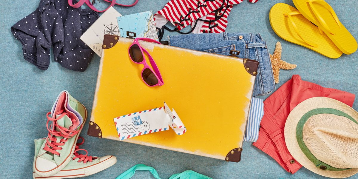 items to put in a suitcase to pack for a honeymoon like sunglasses, a bikini, sneakers