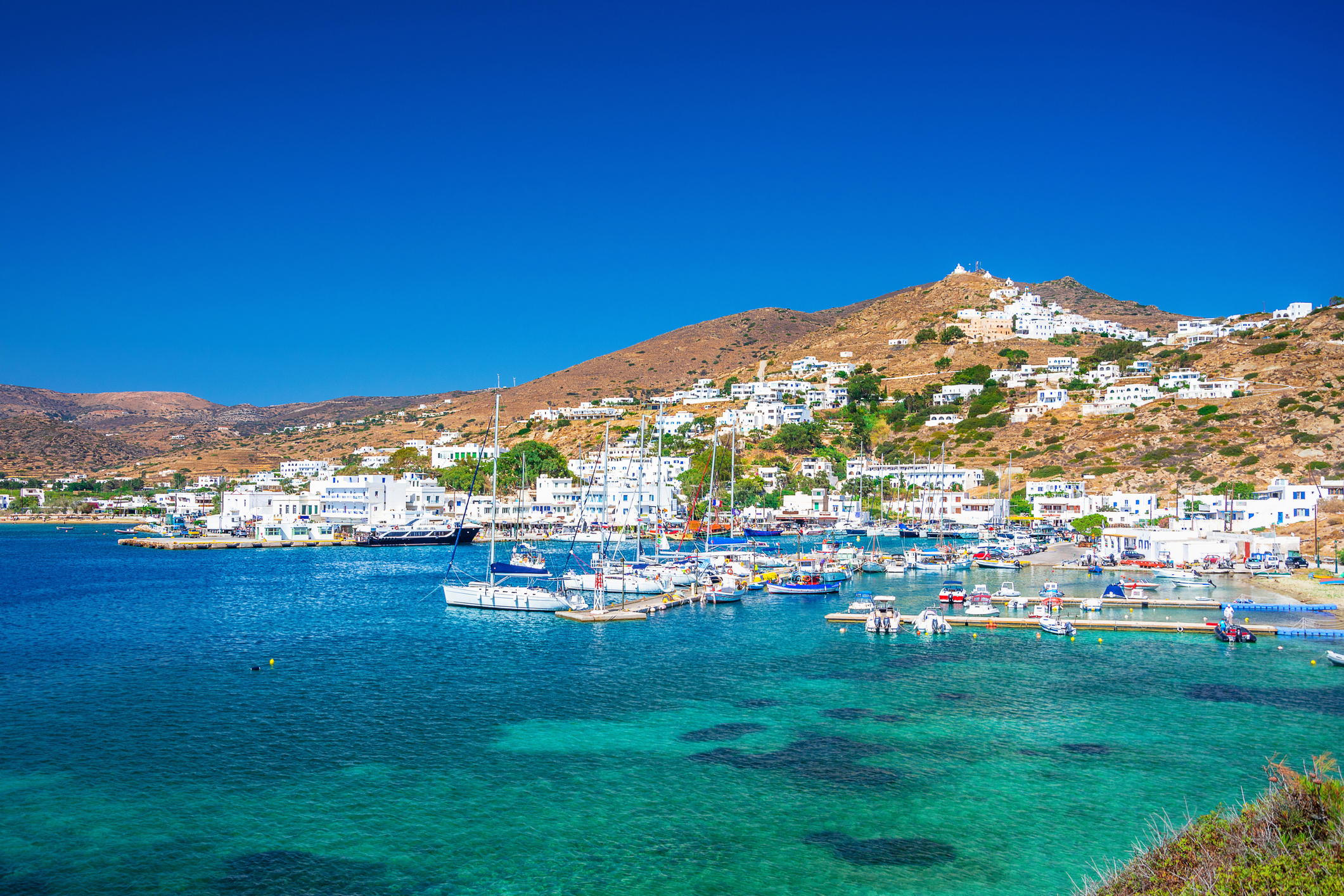 Ios Chora and old harbor at sunset, Cyclades, Greece.