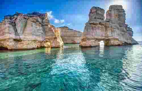 Natural rocky arches with clear transparent waters in Kleftiko, Milos island, Cyclades, Greece