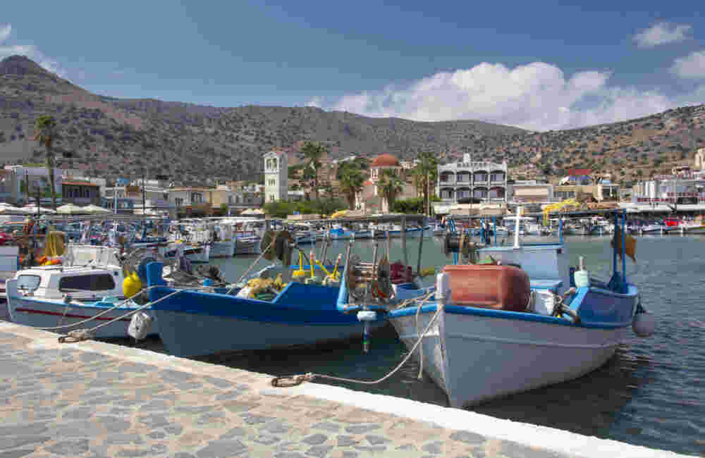 Colorful fishing boats in the small harbor of Elounda