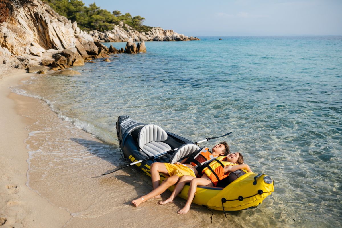 Active teenagers having fun with inflatable raft on their summer vacation