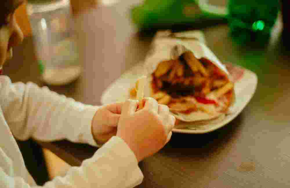 Little boy eating gyros