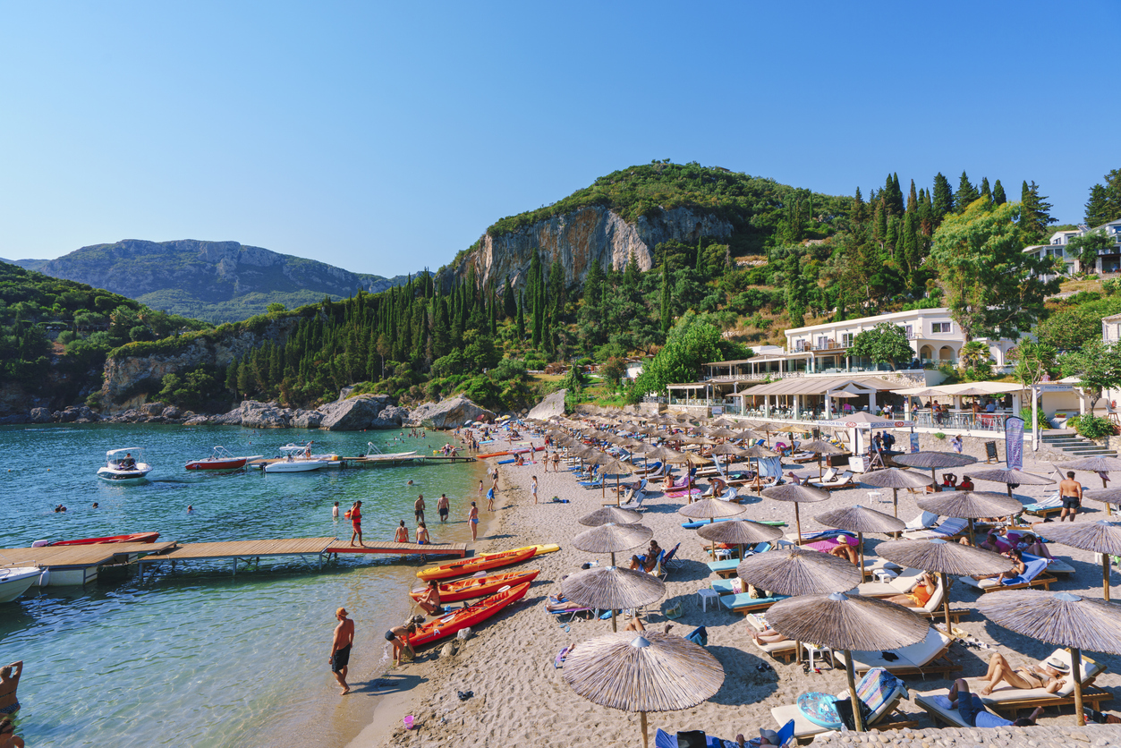 Liapades Beach with relaxing people in Palaiokastritsa Corfu Greece