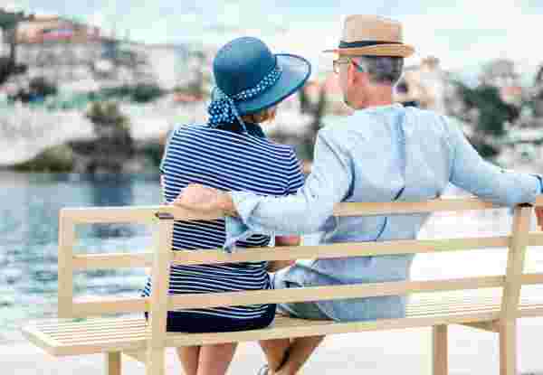 Couple looking at the distant sea view greece for seniors_feature