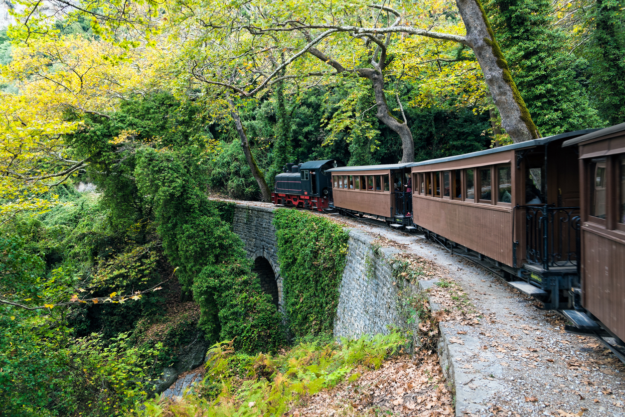 An old traditional train passes over a stone bridge on October 16, 2016 on Mount Pelion, Greece
