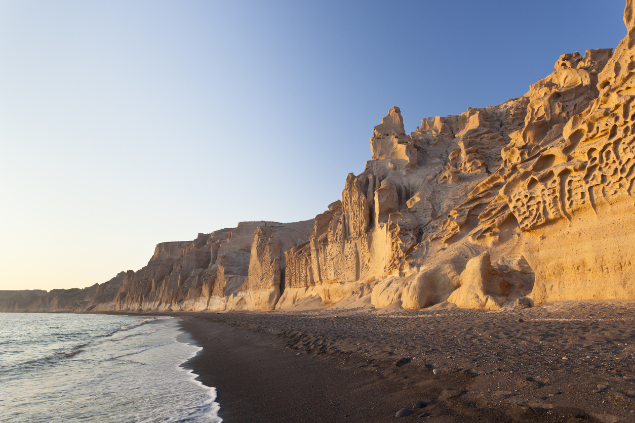 The long Vlychada Beach of Santorini with its impressive pumice cliffs.