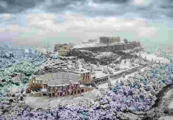 The Parthenon Temple and the Herodion Theater at the Acropolis of Athens, Greece, with ice and snow during a winter snowstorm athens winter_weather in janurary in greece_feature