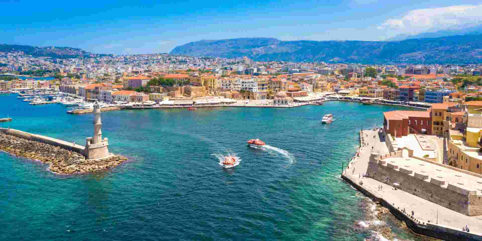 Aerial view of the beautiful city of Chania with it's old harbor and the famous lighthouse, Crete, Greece. chania crete_how to plan a trip to greece_feature