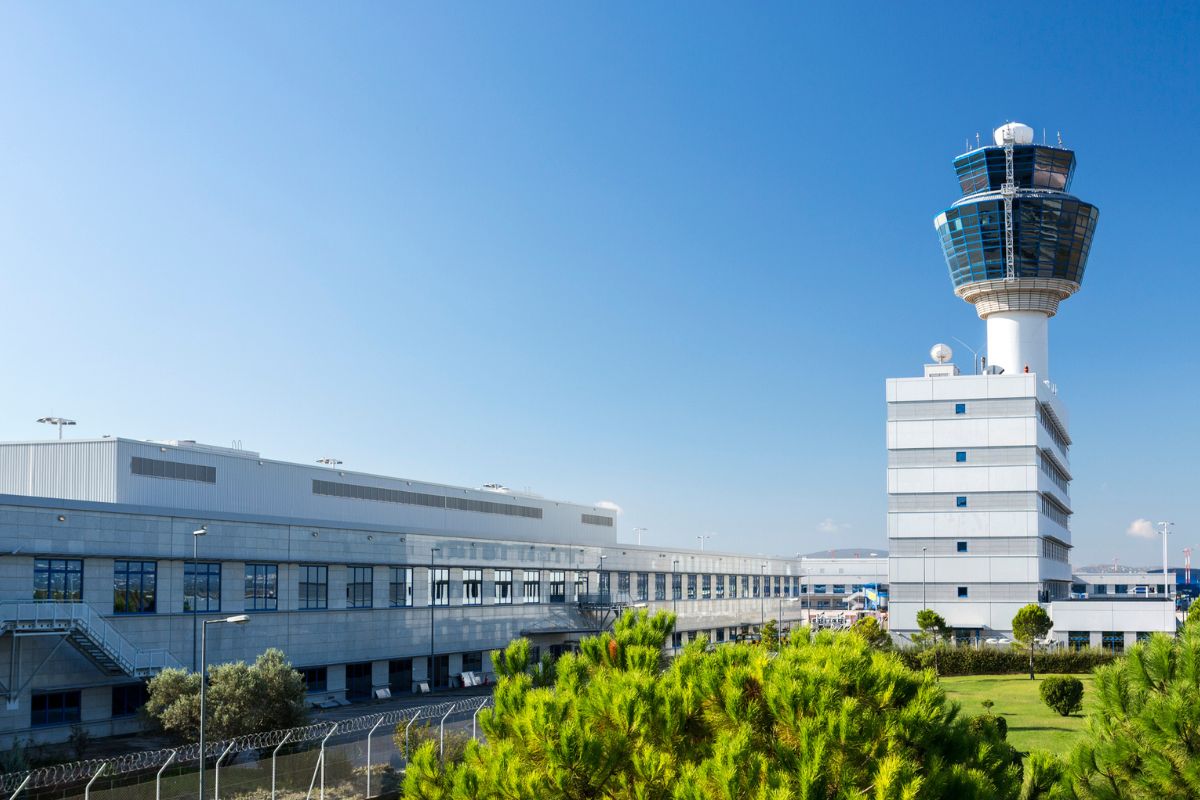 Modern air traffic control tower of the airport of Athens in Greece against clear and beautiful blue sky.