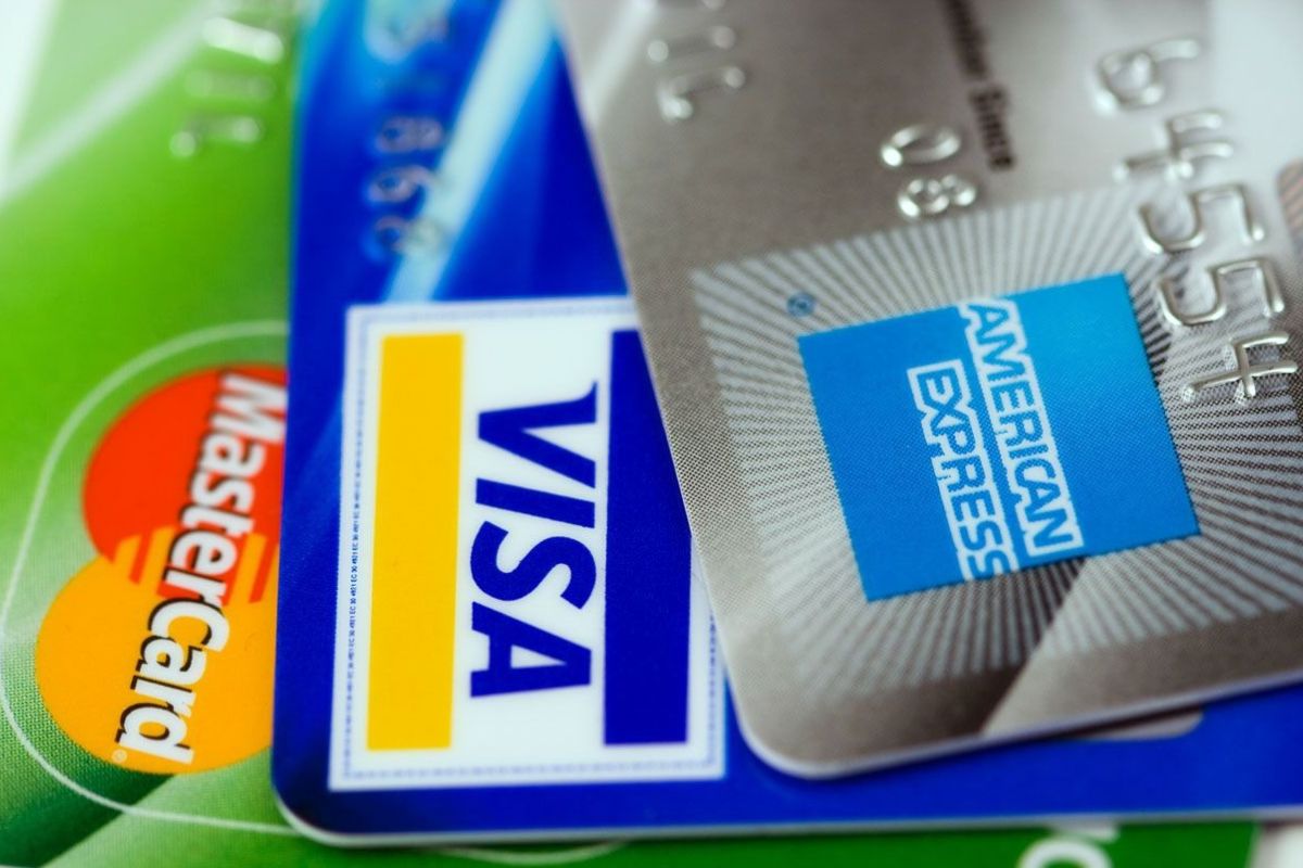 Close-up of major credit cards including Visa, MasterCard, and American Express, representing secure payment options for travel and international purchases.