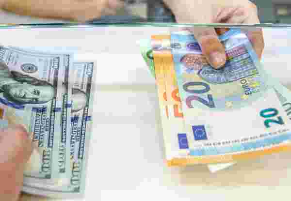 Exchange money, Exchange US dollar or American dollars (USD) for EUR money, A man and women are exchanging dollars for euros. dollars and euro_does greece accept usd_feature