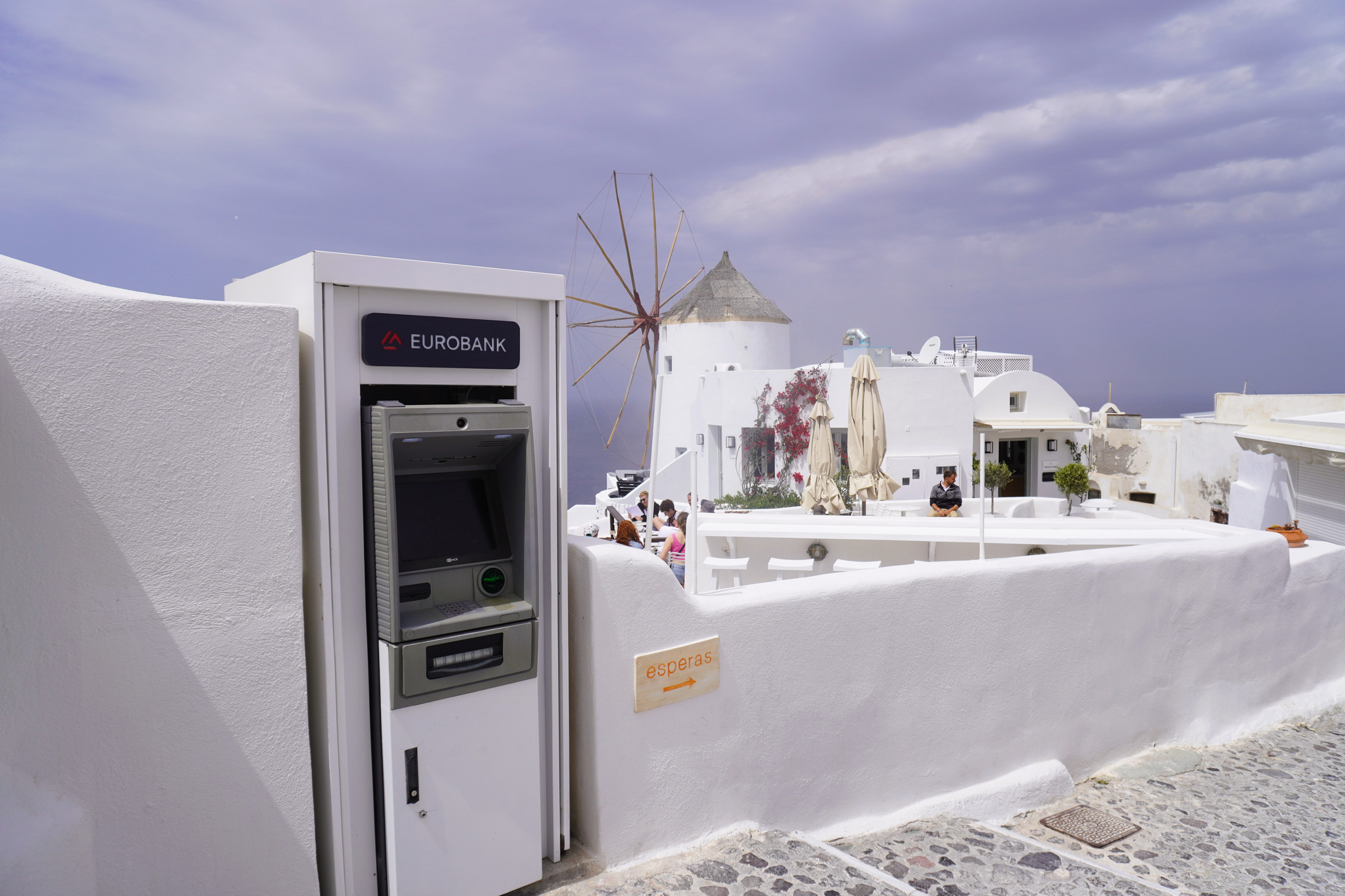Oia, Santorini, Greece, April 17, 2024. The ATM, located conveniently on the tourist trail, blended in well with the town's signature whitewashed walls