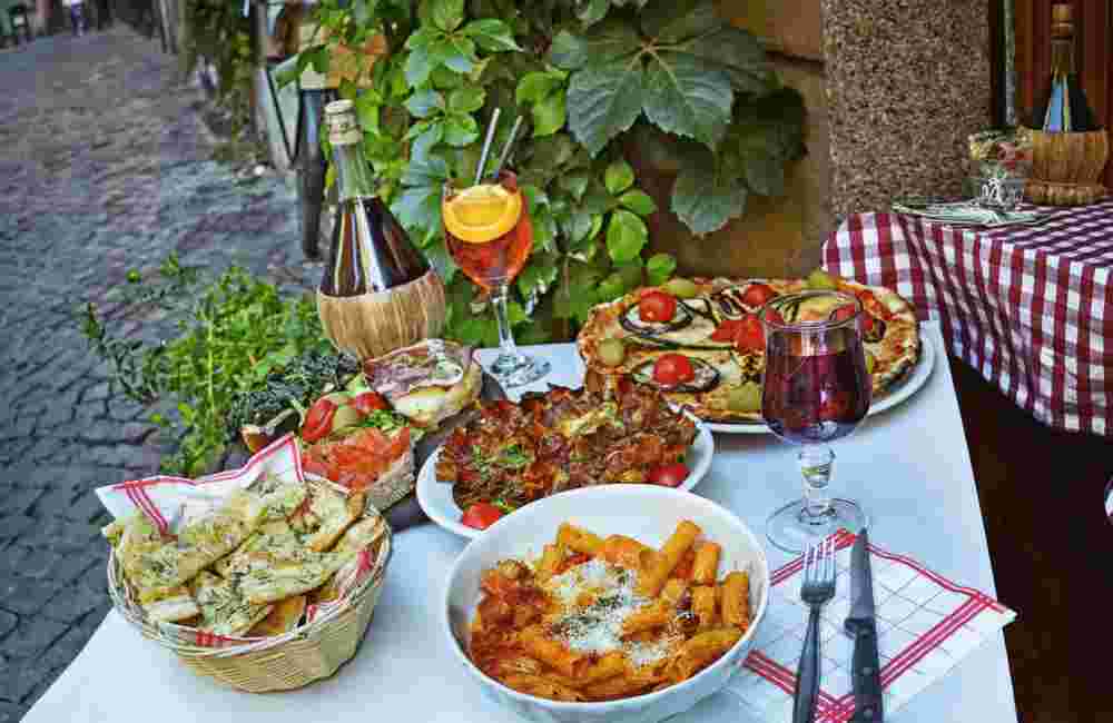 Unidentified people eating traditional italian food in outdoor restaurant