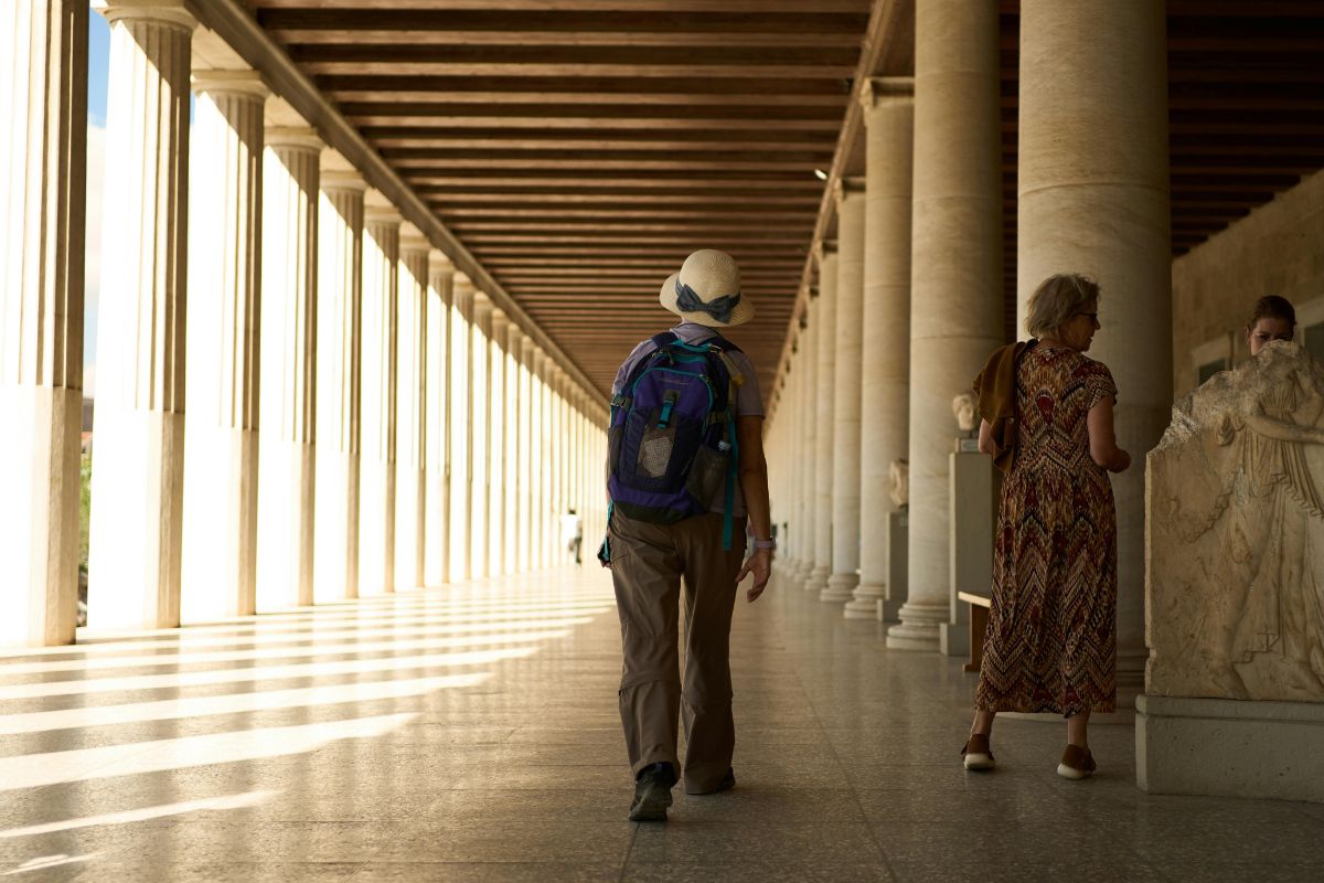Visitors exploring the Stoa of Attalos in the Ancient Agora of Athens, Greece during a sunny October day.