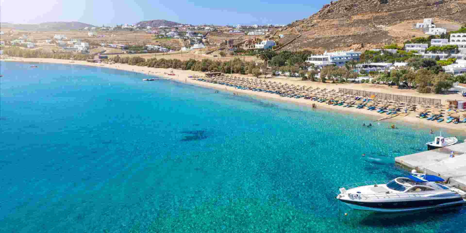 Aerial view to the popular Kalafatis Beach on Mykonos island with pristine, clear sea, Cyclades, Greece kalafatis beach mykonos_where to stay in mykonos_feature
