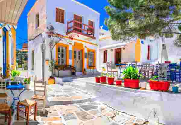 Beautiful Lefkes traditional greek village in Paros island. Charming coffe bars and taverns in colorful narrow streets. Cyclades , Greece Honeymoon in Paros_feature
