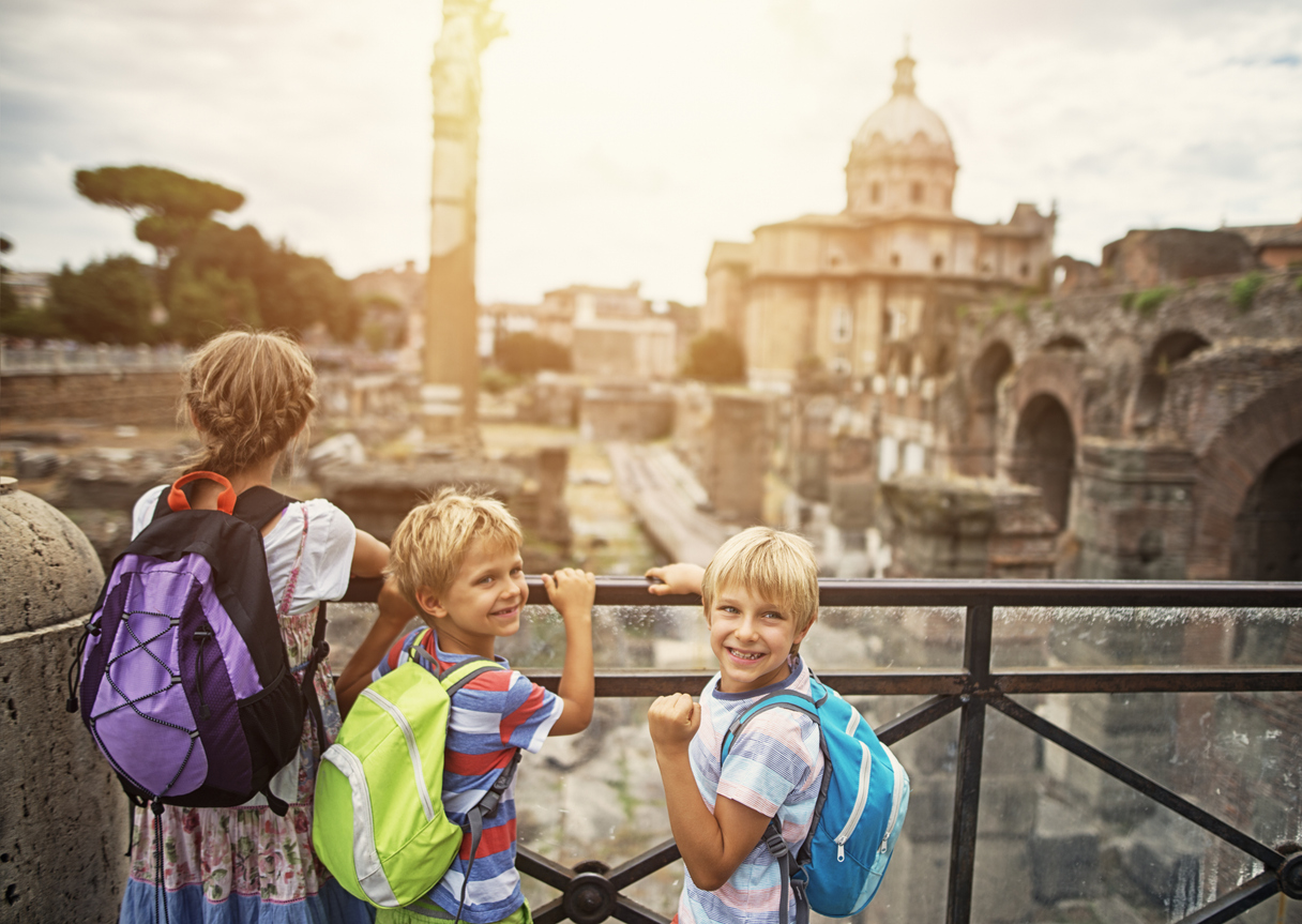 Mother and kids visiting Rome. Excited kids are looking at magnificient Roman Forum.