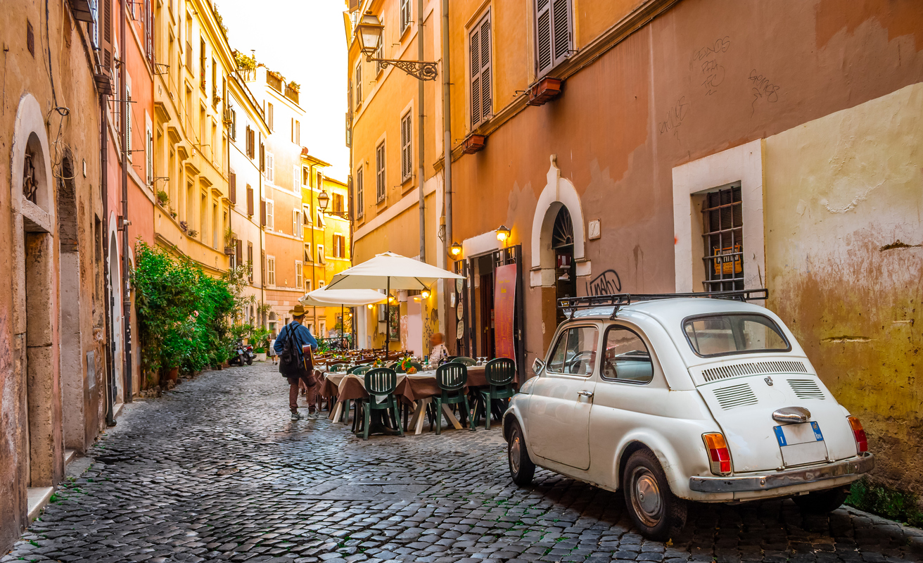 Rome, Italy - May 28, 2017: Cozy street in Trastevere, Rome, Europe. Trastevere is a romantic district of Rome, along the Tiber in Rome. Turistic attraction of Rome.