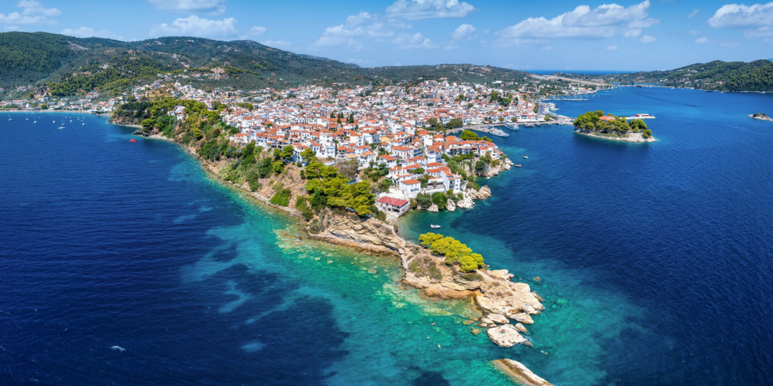 Panoramic aerial view of the town of Skiathos island, Sporades, Greece, with Bourtzi peninsula and Plakes area in front